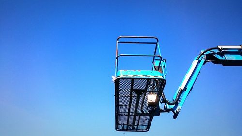 Low angle view of lamp post against clear blue sky