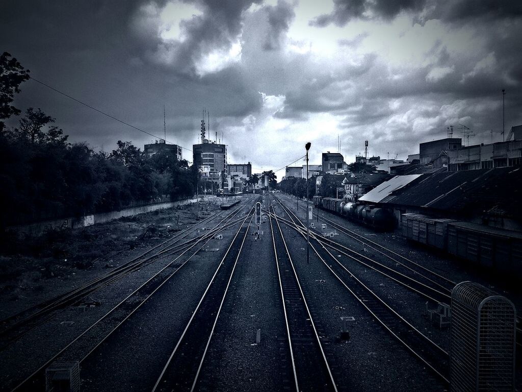 railroad track, transportation, the way forward, diminishing perspective, vanishing point, rail transportation, sky, building exterior, built structure, architecture, cloud - sky, high angle view, public transportation, cloudy, railway track, city, cloud, outdoors, day, no people