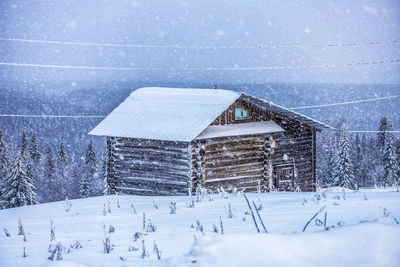 House on snow covered field