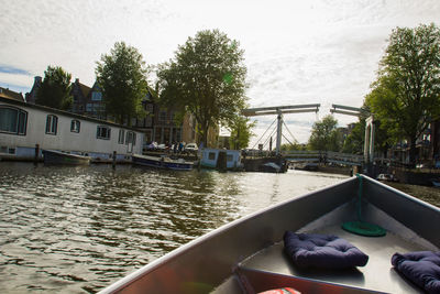 Boats in river with buildings in background