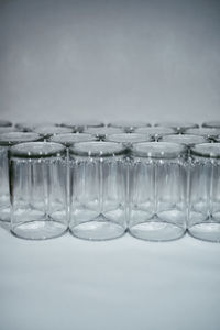 Close-up of glasses on table against white background