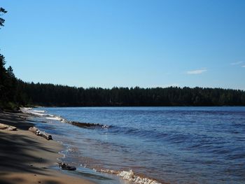 Scenic view of sea against clear blue sky