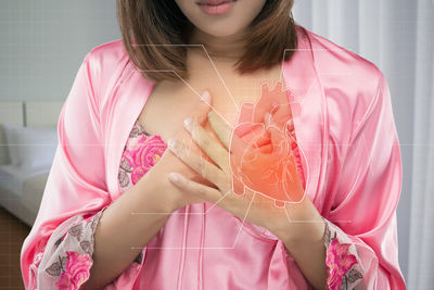 Digital composite image of woman suffering from heart pain