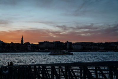 Buildings in city at sunset