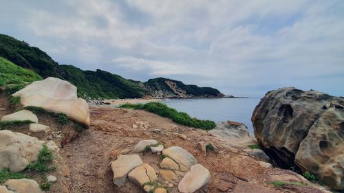 Rocks on beach against sky