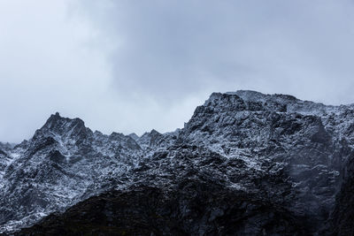 Low angle view of rocky mountains against sky