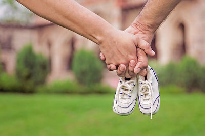 Couple holding hands with small shoes
