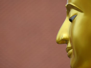 Close-up face of gold buddha statue