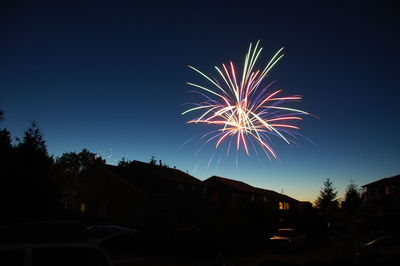 Low angle view of fireworks against sky at night