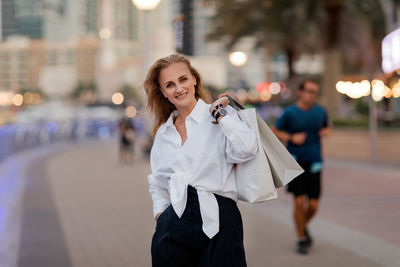 Portrait of an attractive woman with shopping in her hands