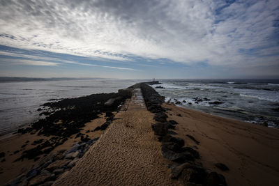 Pier at sea against sky