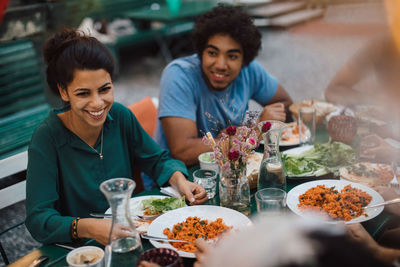 Young woman sitting on table at restaurant