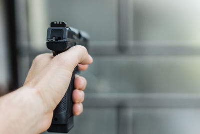 Close-up of hand holding handgun