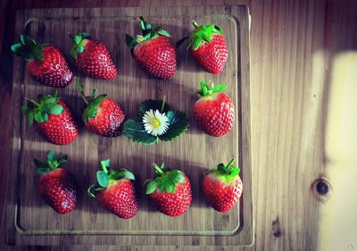 Ripe strawberries on wooden cutting board