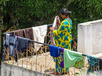 The standing woman drying washed clothes