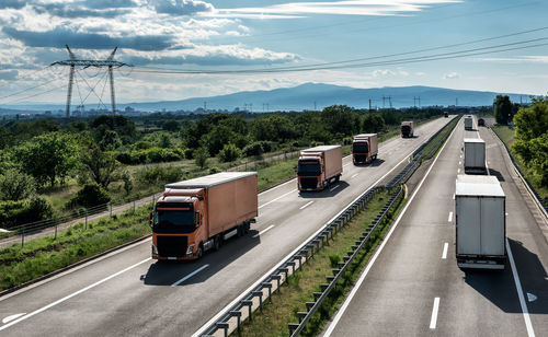 Vehicles on road against sky