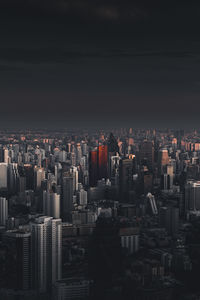 Aerial view of buildings in city against sky