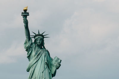 Low angle view of statue of liberty against sky