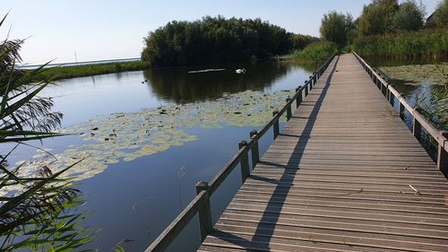 Pier over lake against sky