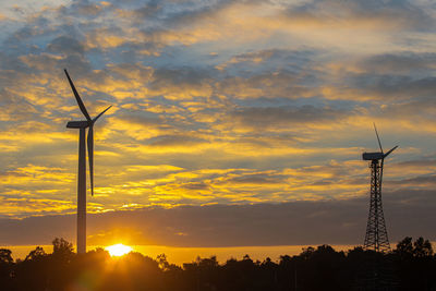 Silhouette of windmill against sky during sunset