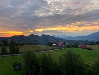 Scenic view of field against sky during sunset