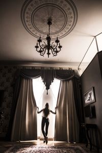 Low angle view of woman in dark room