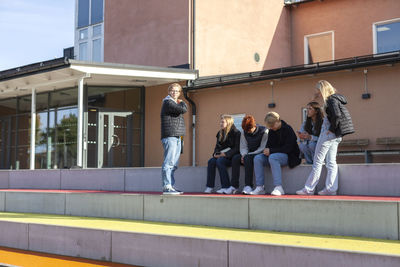 Teenage kids on break in schoolyard