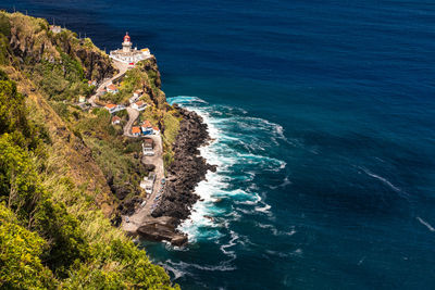 The fantastic view of the lighthouse from nordeste on the steep coast of azores island of sao miguel