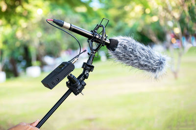 Close-up of camera hanging on tree