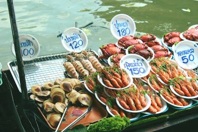 High angle view of seafood for sale in market against lake