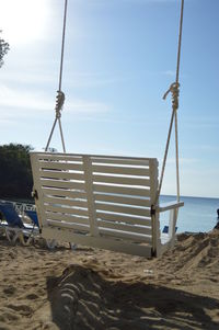 Lifeguard hut on beach against sky