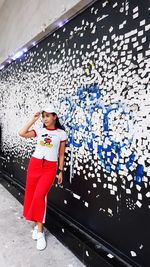 Woman standing against wall