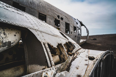 Old abandoned car against sky