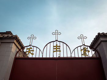 Low angle view of street light against building