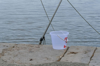 Close-up of deck chair by sea