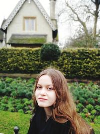 Portrait of beautiful young woman in lawn