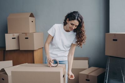 Side view of young woman working at home