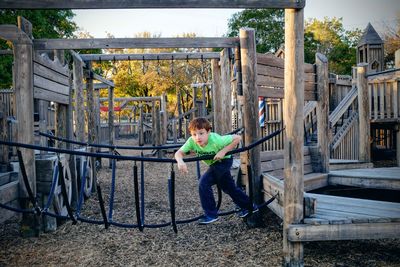 Full length of man using mobile phone outdoors