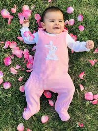 Portrait of cute baby girl on field