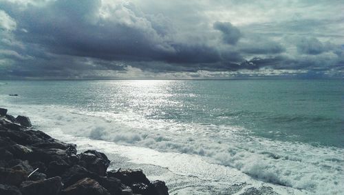 Scenic view of sea against cloudy sky
