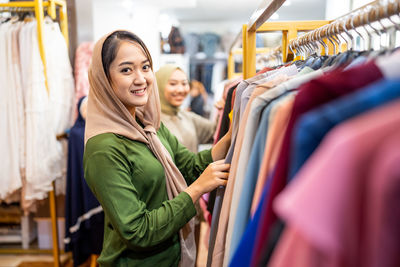 Portrait of smiling woman in clothing store