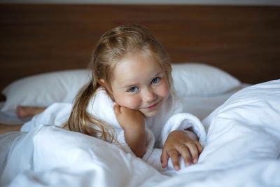 Close-up of cute baby boy sleeping on bed at home