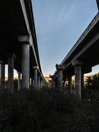 Low angle view of bridge against sky at sunset