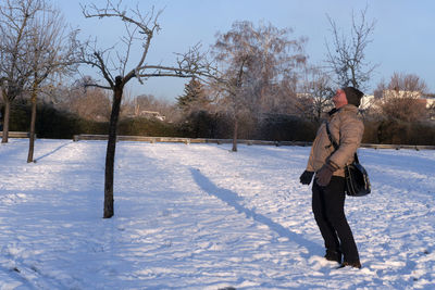 Full length of woman on snow covered field