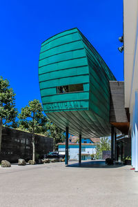 Low angle view of buildings against clear blue sky