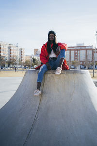 Portrait of man skateboarding on skateboard in city