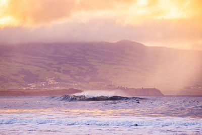 Waves in the atlantic ocean, before sunset, colorful sky, azores travel destination.