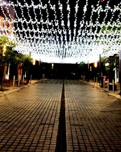 Illuminated underground walkway at night