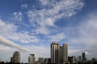 Modern buildings in city against sky