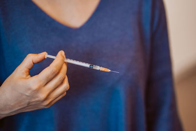 Close-up of hand holding cigarette